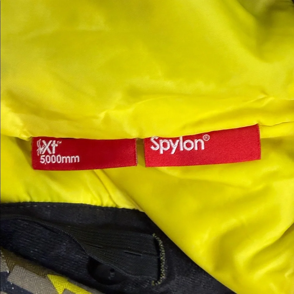 SPYDER Boys' Propulsion ski pants with an olive, black, and yellow plaid pattern
